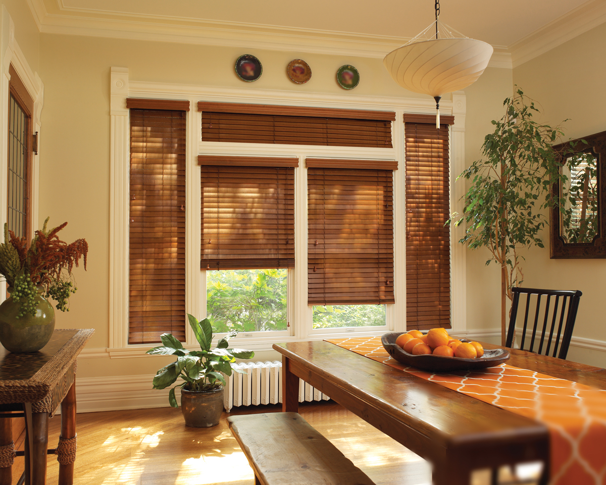 Custom wood blinds in a sunlit dining room