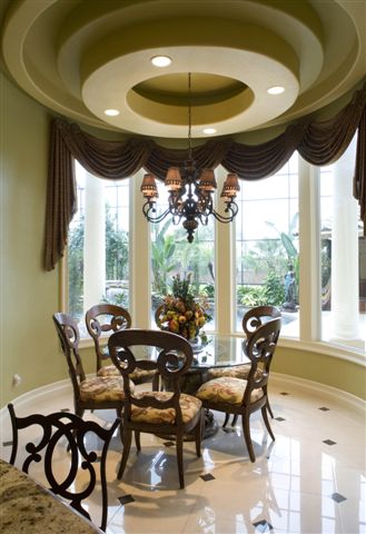 Formal swagged valance over a bay window in a dining room