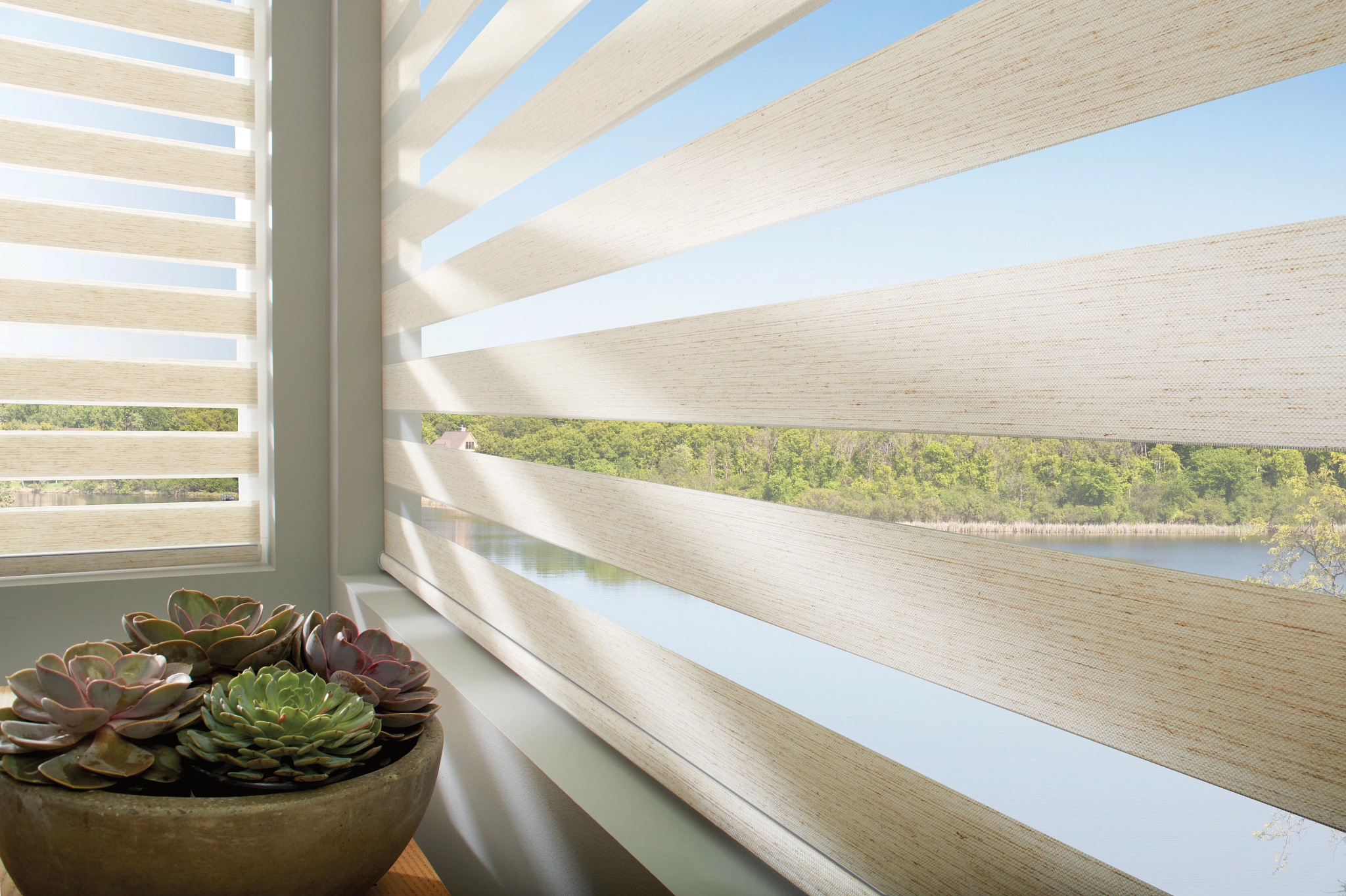 Sheer window shadings with soft fabric vanes filtering daylight