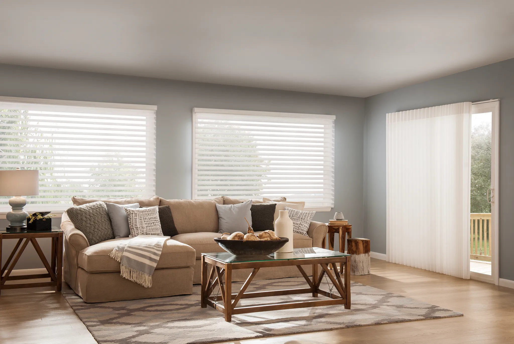Sheer shades and vertical blinds in a sunlit living room