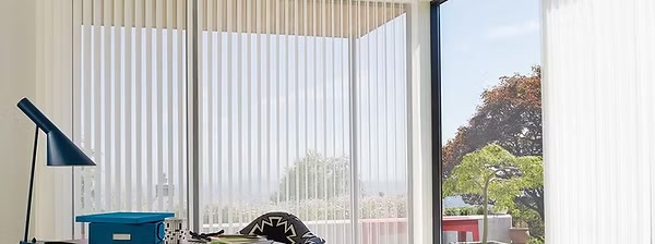 Luminette privacy sheers drawn across a bright bedroom window